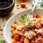 A vibrant plate of Fiery Arrabiata Penne featuring al dente pasta coated in a spicy tomato sauce, garnished with fresh basil and chili flakes.